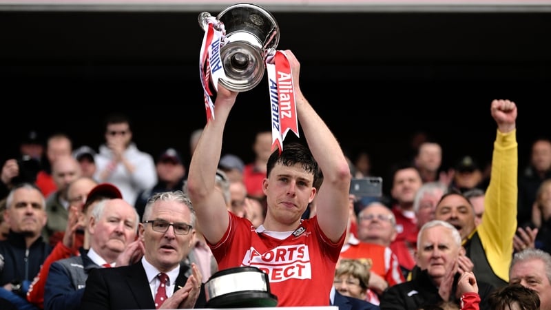 Cork captain Robert Downey lifts the cup