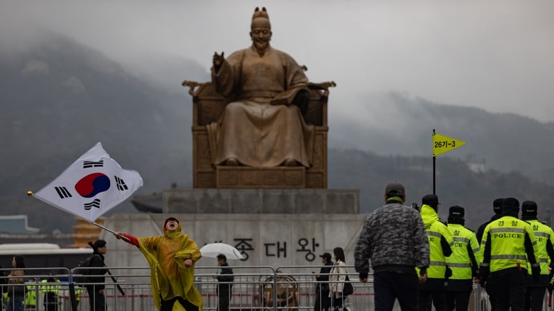 A supporter of Yoon Suk Yeol waves a South Korean flag and denounces the Constitutional Court