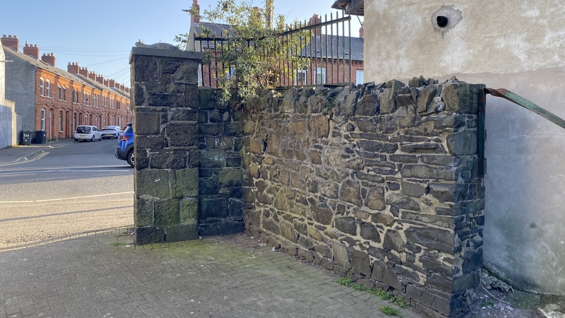 The remaining part of a wall at the entrance to the workhouse burial ground