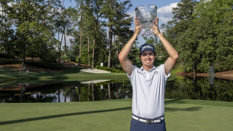 Nicolas Echavarria of Colombia lifts the Par 3 Contest trophy