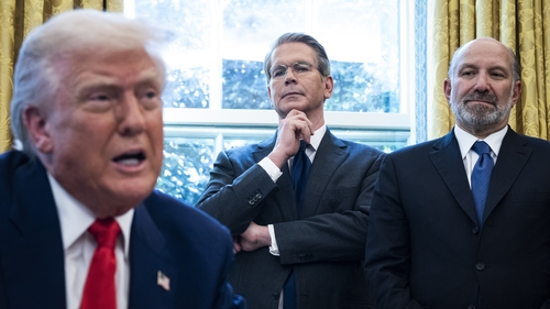 Scott Bessent and Howard Lutnick listen as President Donald Trump speaks in the Oval Office