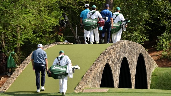 Shane Lowry follows playing partners Bryson DeChambeau and Hideki Matsuyama across the Hogan Bridge