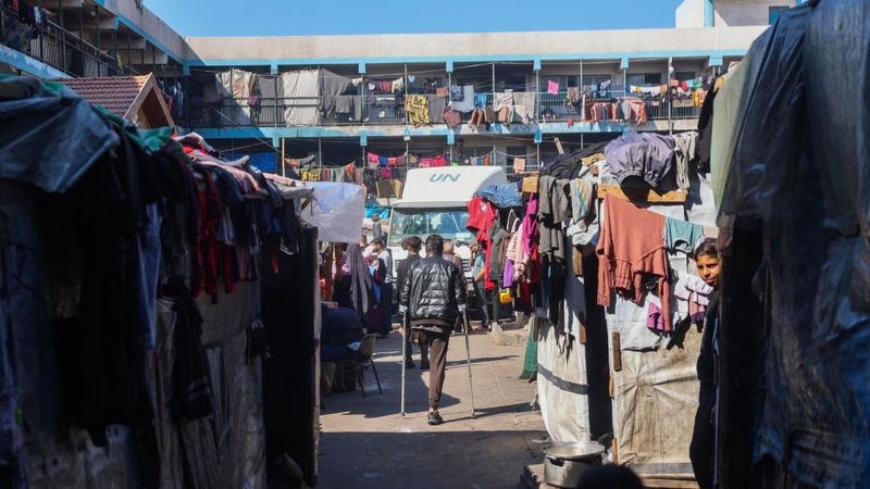A man walks with crutches at a United Nations Relief and Works Agency for Palestine Refugees school-turned-camp for internally displaced people in Gaza