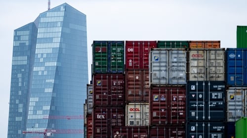 Shipping containers in the port of Frankfurt with the headquarters of the European Central Bank in the background