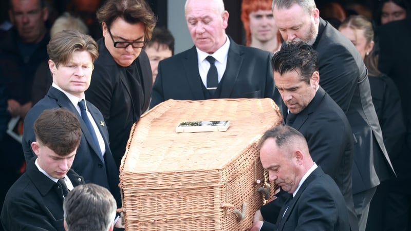 Colin Farrell with his brother Eamon (glasses) carry the coffin of their father Eamon at his funeral in Dublin