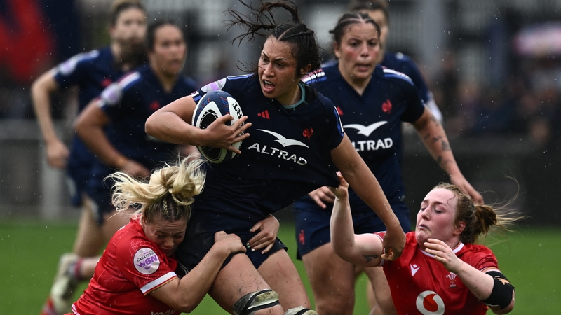 France's lock Manae Feleu is tackled by Wales' hooker Kelsey Jones (L)