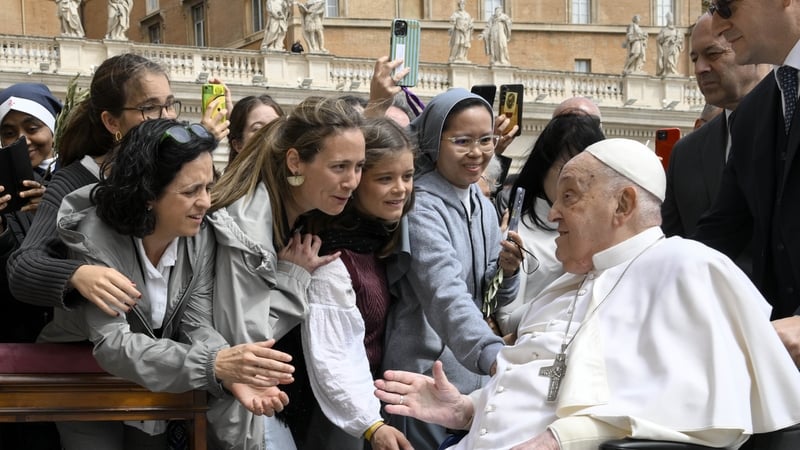Pope Francis greets worshippers at the end of a Palm Sunday Mass at St Peter's Square in the Vatican