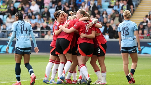 Manchester United's players celebrate Grace Clinton's goal