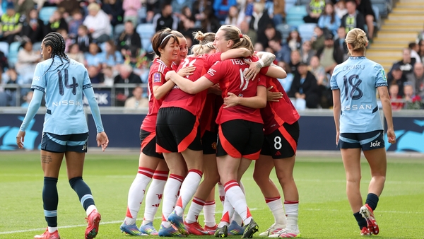 Manchester United's players celebrate Grace Clinton's goal