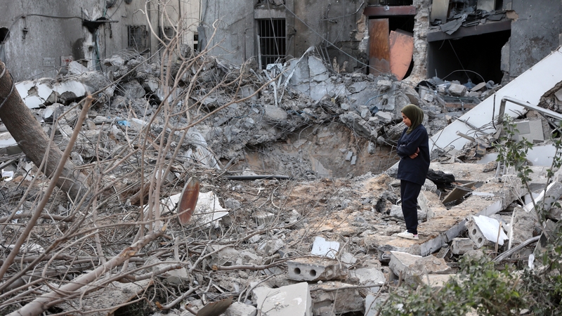 A woman stands amid the rubble in the aftermath of an Israeli strike on the Al-Ahli hospital in Gaza