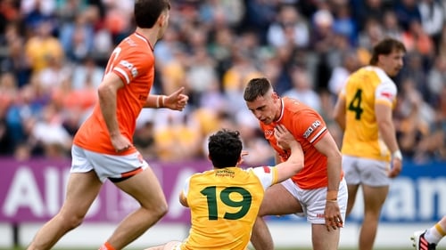 Greg McCabe of Armagh and Conor Stewart of Antrim exchange glances