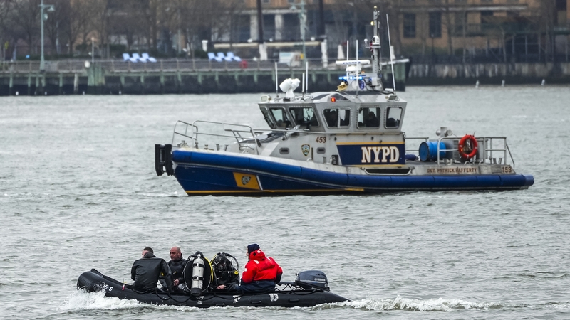 NYPD scuba divers team search the site of the crashed helicopter on New York's Hudson River
