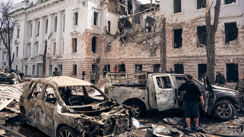 Civilian cars lie burned out at the site of a Russian ballistic missile strike on the city centre in Sumy, Ukraine
