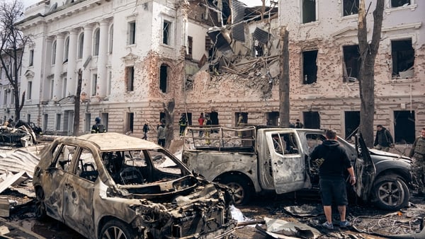 Civilian cars lie burned out at the site of a Russian ballistic missile strike on the city centre in Sumy, Ukraine