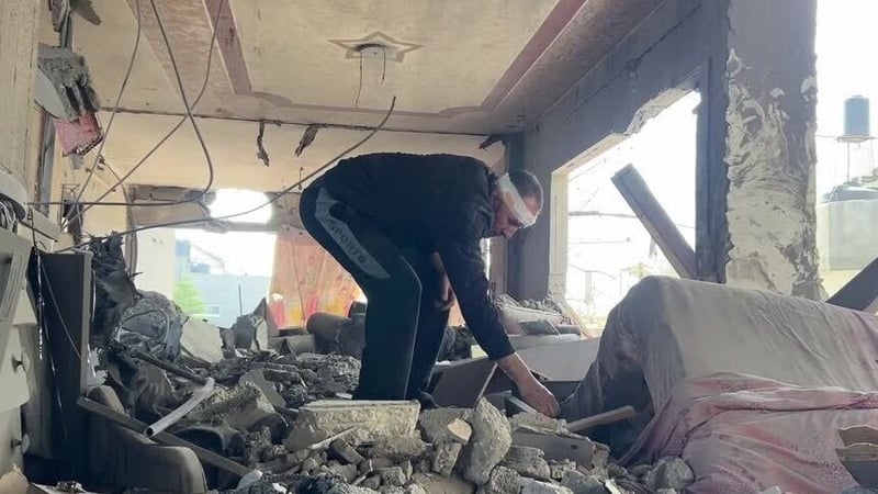 A man searches the rubble of his home in Jabalia in the Gaza Strip