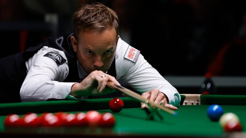 Ali Carter plays a shot with the rest in his win over He Guoqiang