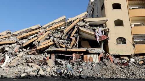 A man walks near a destroyed building in nuseirat refugee camp in Deir al-Balah
