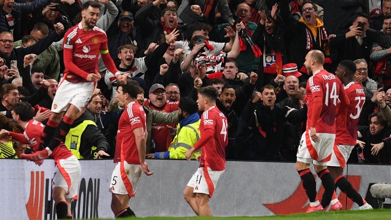 Manchester United players celebrate Harry Maguire's winner with their ecstatic fans