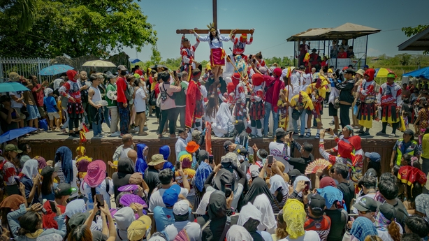 Female penitent Precy Valencia is nailed to a cross during Good Friday crucifixions in the Philippines