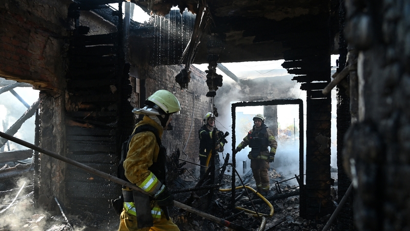Ukrainian rescuers work to extinguish a fire in a sewing factory following a missile attack in Kharkiv