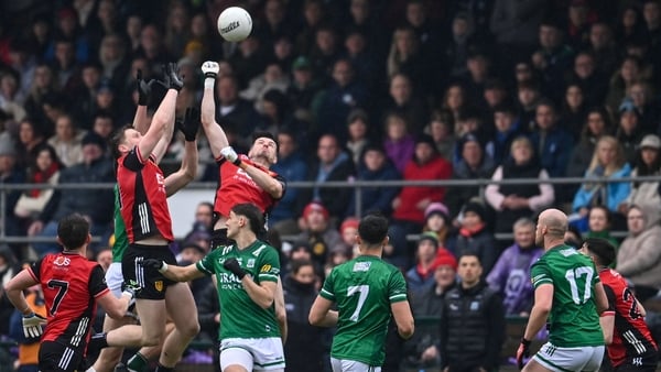 Odhran Murdock and James Guinness of Down in action against Fermanagh's Joe McDade