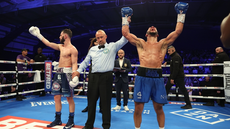 Caoimhin Agyarko has his hand raised in victory following the bout with Ryan Kelly
