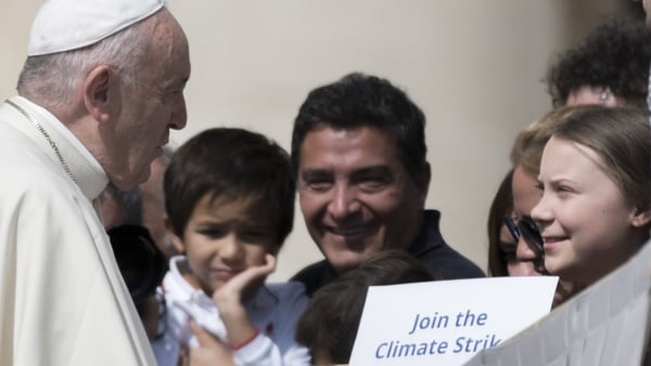 Pope Francis greets Swedish teenage environmental activist Greta Thunberg, right, during his weekly general audience in St Peter's Square, at the Vatican, on 17 April 2019
