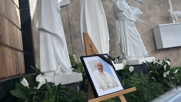 Black mourning scarf draped across Pope Francis's photograph at Knock