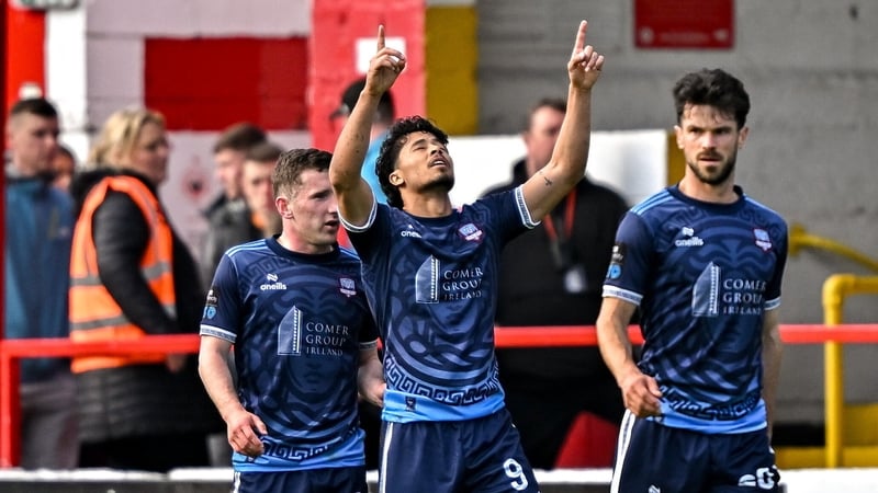 Moses Dyer points to the heavens after scoring the first goal of his brace
