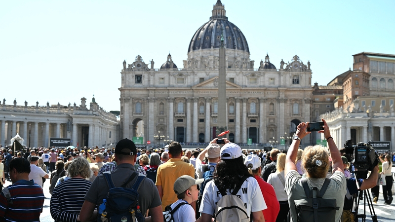 Visitors gather near St Peter's Square a day after the Pope's death