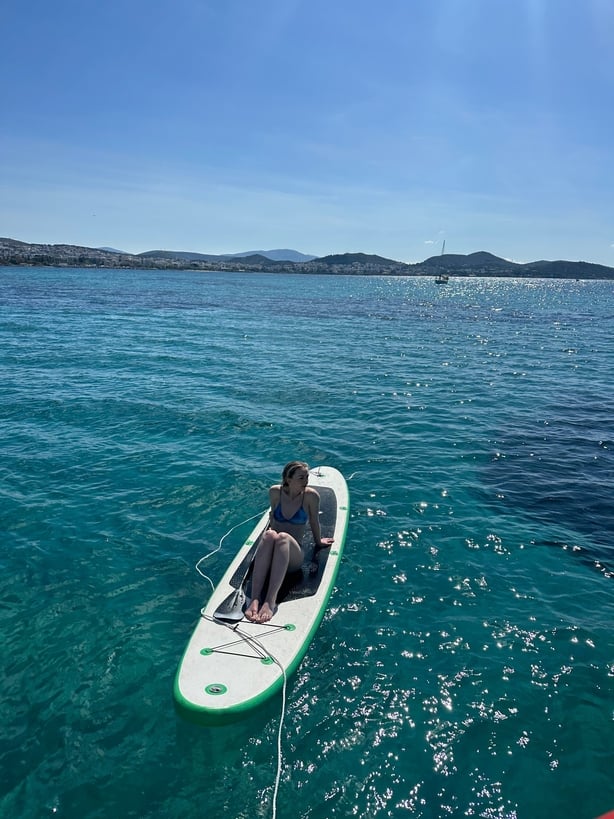 Camilla relaxing on a paddle board during the morning cruise