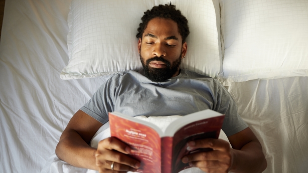 Elderly couple reading in bed