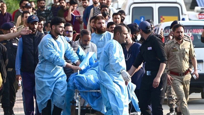 Paramedics rush an injured tourist to hospital in Anantnag, India, after Islamist militants killed 26 people and injured 17 others