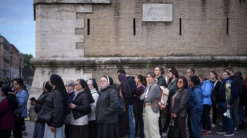 People queue up along the walls of the Vatican City to pay their respects to late Pope Francis as his body lies in state