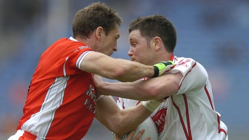 Tyrone's Enda McGinley is tackled by Armagh captain Kieran McGeeney during the 2005 Ulster final replay at Croke Park