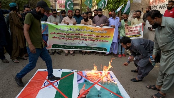 Activists of Pakistan Sunni Tehreek party burn Indian national flag and a portrait of India's Prime Minister Narendra Modi, during an anti-India protest