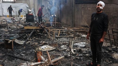 Palestinians inspect damage after an Israeli strike a school-turned-shelter in Gaza City