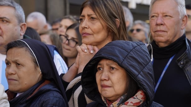 Crowds gather along the road outside of the Basilica Santa Maria Maggiore 