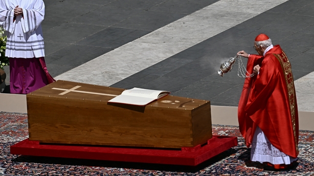 Italian cardinal Giovanni Battista Re swings an incense burner towards the coffin of late Pope Francis with the book of the gospels displayed on it during the funeral ceremony
