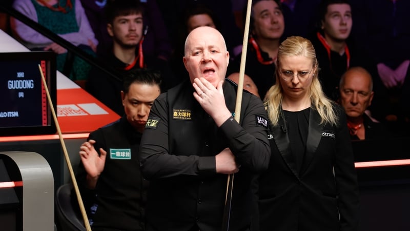 John Higgins deliberates over a shot in Sheffield
