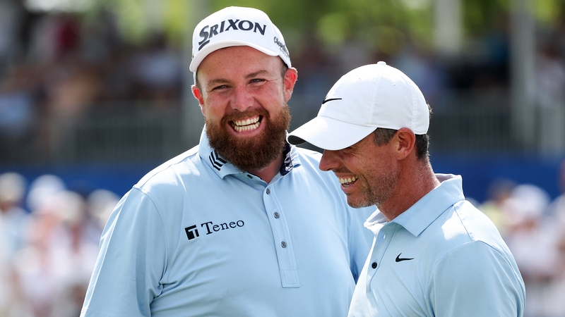 Shane Lowry and Rory McIlroy are all smiles after the latter's eagle putt on the 18th