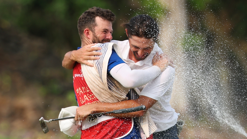 Marco Penge celebrates with his caddy after winning the Hainan Classic