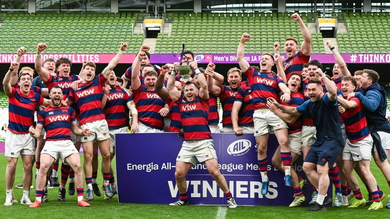 Clontarf captain Dylan Donnellan hoists the cup aloft