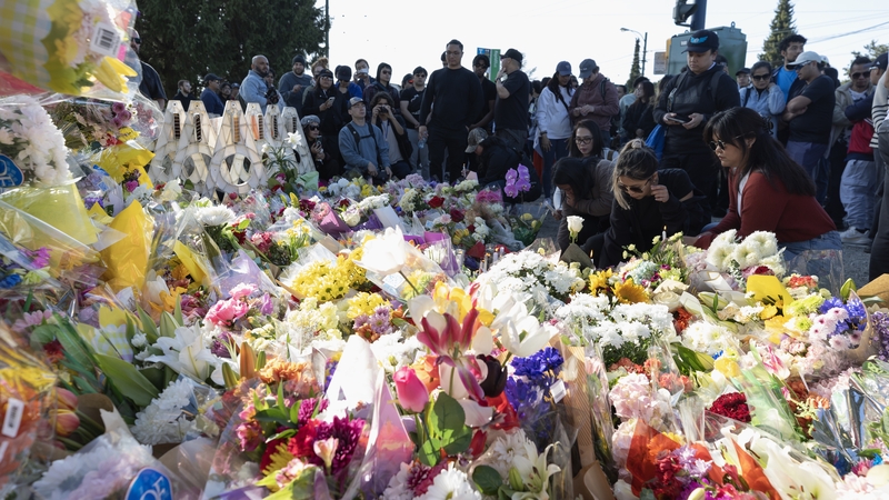 People attend a candlelight vigil near the scene where a car drove into a crowd of people during the Lapu Lapu Festival