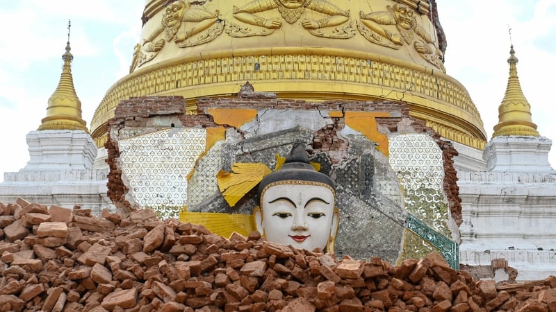A damaged Buddha statue surrounded by debris at Lawkatharaphu Pagoda in Inwa on the outskirts of Mandalay