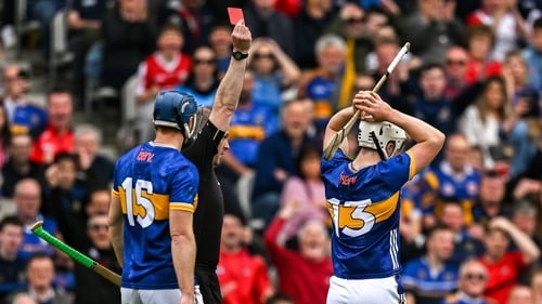 Darragh McCarthy (R) of Tipperary is shown a red card by referee Johnny Murphy