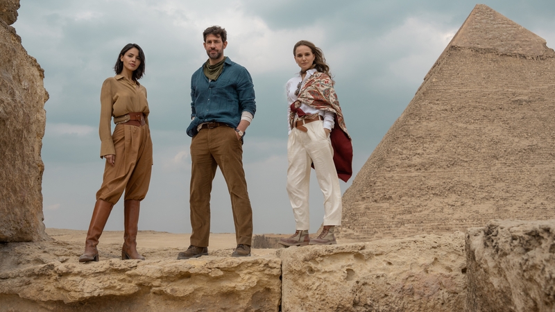 John Krasinski and Natalie Portman are out to find "the most important archaeological discovery in history". Eiza González (left) is the mysterious agent out to stop them