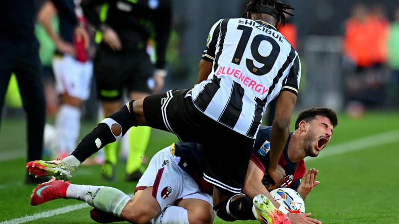 Bologna's Riccardo Orsolini is on the end of a meaty challenge from Kingsley Ehizibue of Udinese