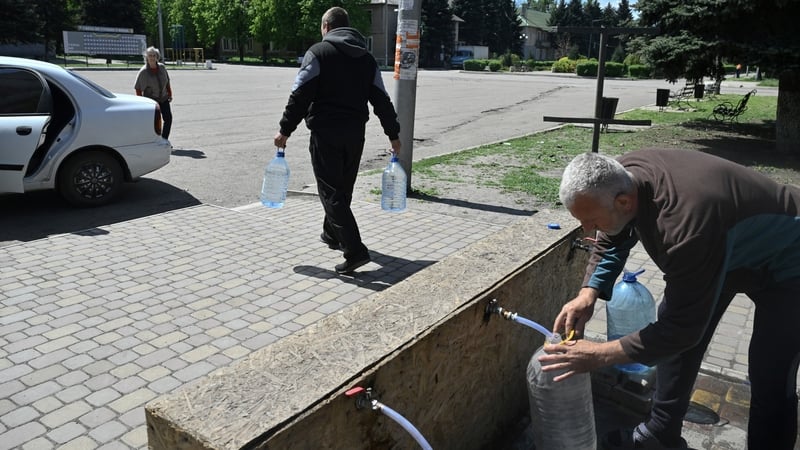 Locals collect drinking water at a distribution point in the town of Bilytske, in the Donetsk region in Ukraine, yesterday