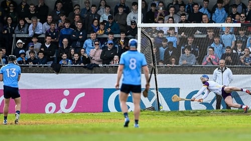 Wexford goalkeeper Mark Fanning dives for that penalty taken by Seán Currie (L) which was eventually awarded as Dublin's third goal at Parnell Park